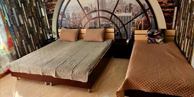 two beds in a room with a view of a city at Курортно студио in Sunny Beach