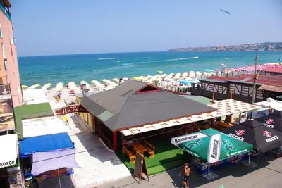 an overhead view of a beach with umbrellas and the ocean at Апартаменти Зафи in Sozopol