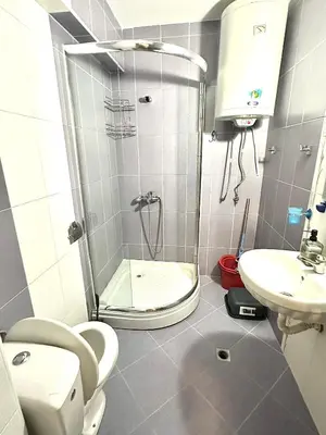 a bathroom with a shower and a toilet and a sink at Апартаменти Зафи in Sozopol