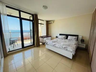 a bedroom with a bed and a view of the ocean at Dolce Vita sea view apartment in Sveti Vlas