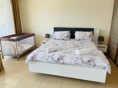 a bedroom with a large bed with two pillows at Dolce Vita sea view apartment in Sveti Vlas