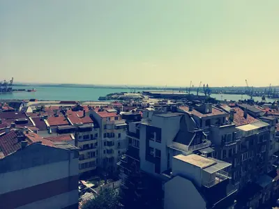 an aerial view of a city with buildings and the water at Апартамент за гости ВО1 in Burgas City