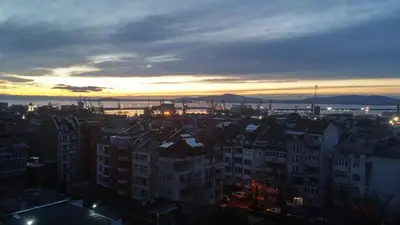 a view of a city at sunset with buildings at Апартамент за гости ВО1 in Burgas City