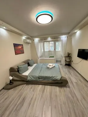 a bedroom with a large bed and a tv at Apartment in Varna City
