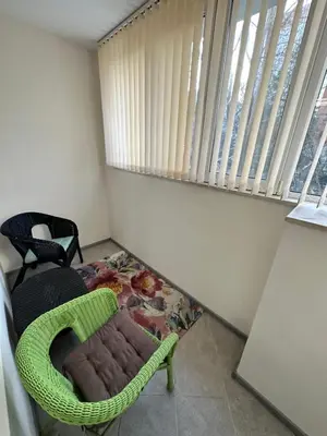 a room with a green chair and a window at Apartment in Varna City