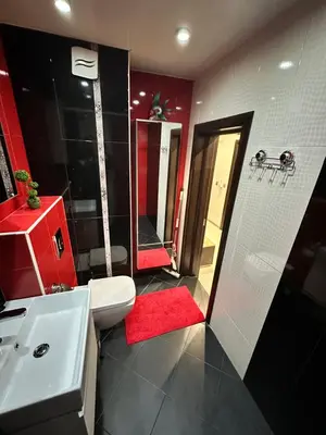 a bathroom with a white toilet and a sink at Apartment in Varna City