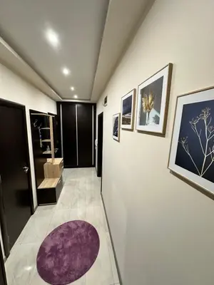 a bathroom with a purple rug on the wall at Apartment in Varna City