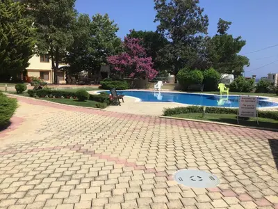a brick walkway around a swimming pool at SunnySeasons Apartment with swimming pool view in Byala