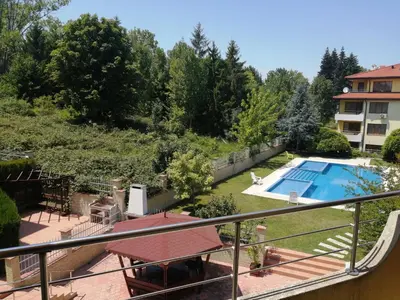 a view from the balcony of a house with a swimming pool at SunnySeasons Apartment with swimming pool view in Byala