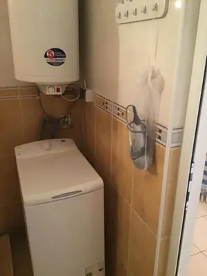 a small bathroom with a toilet and a sink at SunnySeasons Apartment with swimming pool view in Byala