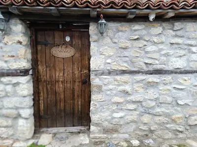 a wooden door on the side of a stone building at Guest House Soirée in Nesebar
