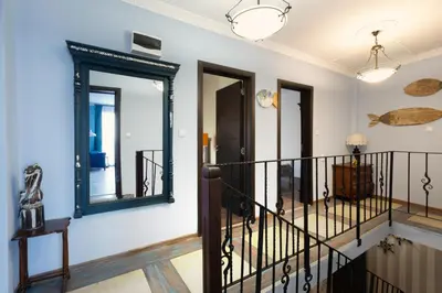 a staircase in a house with mirrors on the wall at Guest House Soirée in Nesebar