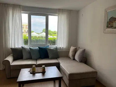 a living room with a couch and a window at Sozopoli Hills Apartment A6 in Sozopol