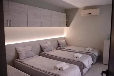 a room with two beds and a couch at Стаи за гости Гебедже in Beloslav