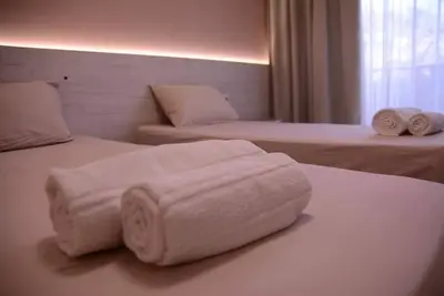 a hotel room with two beds with towels on them at Стаи за гости Гебедже in Beloslav