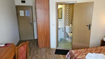 a room with a bathroom with a toilet and a sink at Caprice Family Hotel in Varna City