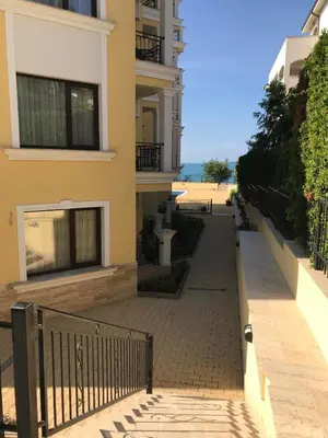 an empty sidewalk next to a building with the beach at Horizon Katrina Apartments - Sea line & Beach Access in Sveti Vlas