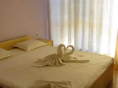 a towel animal sitting on top of a bed at House Apartments Black sea Hotel in Obzor