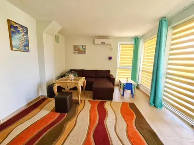 a living room with a couch and a table at House Apartments Black sea Hotel in Obzor
