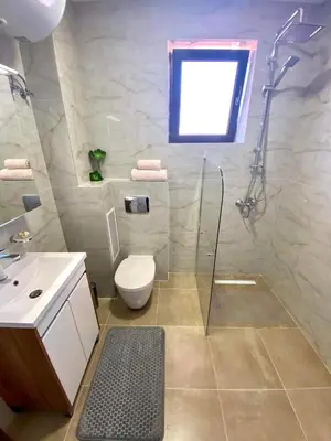 a bathroom with a shower and a toilet and a sink at Sozopol Dreams apartman 42 in Sozopol