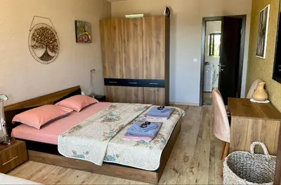 a bedroom with a bed with pink pillows on it at Sozopol Dreams apartman 42 in Sozopol