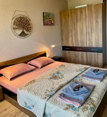 a bedroom with a bed with towels on it at Sozopol Dreams apartman 42 in Sozopol