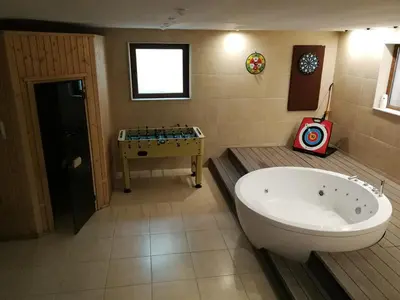 a large bathroom with a tub and a sink at Wonderful family villa with sea view in Byala