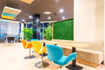 a room with a table and chairs and a green wall at Admiral Plaza Hotel in Sunny Beach