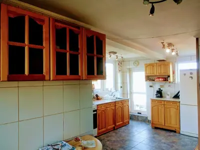a kitchen with wooden cabinets and a white refrigerator at гостевой дом у Снежаны in Provadiya