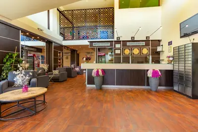 a lobby of a store with tables and chairs at Hotel Julia in Sveti Vlas