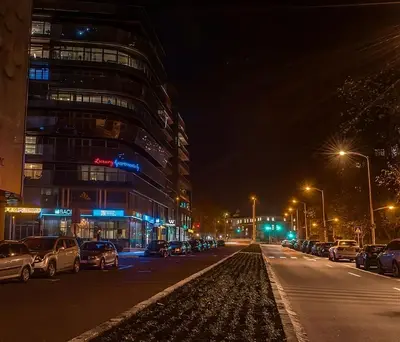 a city street at night with cars parked at Luxury Apartments Burgas in Burgas City