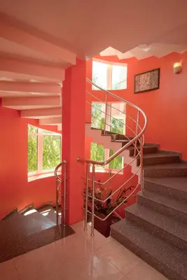 a staircase in a building with red walls at Iris Beach Hotel in Sveti Vlas