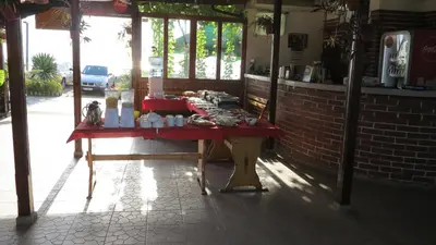 a table in a building with a red table at Bisser Obzor in Obzor