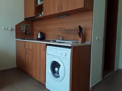 a washing machine in a kitchen with a sink at FORT NOKS NESSEBAR B2-203 Private Studio Sunny Beach in Sunny Beach