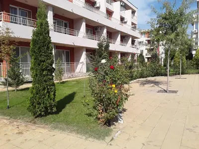 a building with bushes and flowers in front of it at FORT NOKS NESSEBAR B2-203 Private Studio Sunny Beach in Sunny Beach