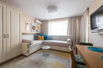 a small living room with a couch and a window at Aquamarine in Pomorie