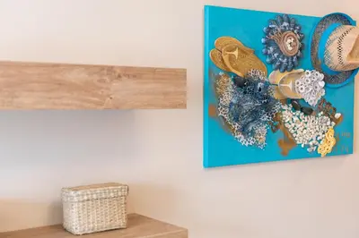 a painting hanging on a wall in a room at Aquamarine in Pomorie