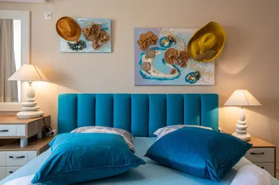 a blue bed with two pillows in a bedroom at Aquamarine in Pomorie