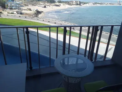 a balcony with a chair and a view of the beach at PARADISO 'В' 310 Private Room Nessebar in Nesebar