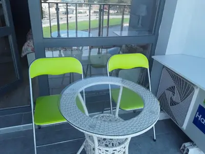 a table and two chairs on a balcony at PARADISO 'В' 310 Private Room Nessebar in Nesebar