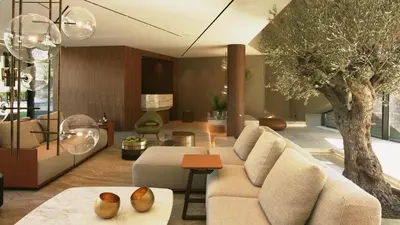 a living room with a couch and a tree at Vaya Beach Resort in Emona