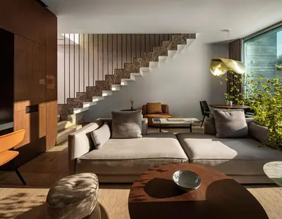a living room with a couch and a staircase at Vaya Beach Resort in Emona