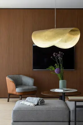a living room with a couch and a pendant light at Vaya Beach Resort in Emona