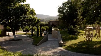 a park with a bench in the middle of a path at Vaya Beach Resort in Emona