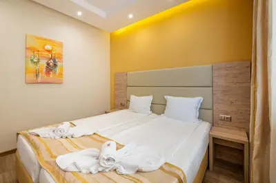 a bedroom with a bed with towels on it at Perla Apartments First Line in Nesebar