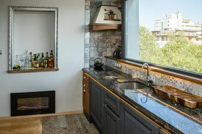 a kitchen with a sink and a window at ART LUXURY Apartment in Burgas City