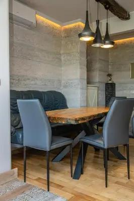 a dining room with a wooden table and chairs at ART LUXURY Apartment in Burgas City
