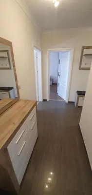 a room with a kitchen with a counter and a hallway at CENTRAL Lux Apartment in Varna City