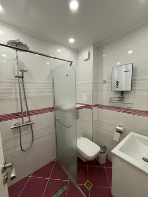 a bathroom with a shower and a toilet and a sink at CENTRAL Lux Apartment in Varna City