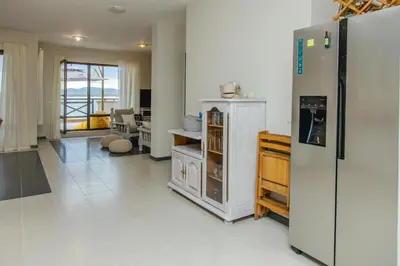 a kitchen with a refrigerator and a living room at Lovely 3BD flat with PARKING and SEA VIEW by Flаt Manаger in Chernomorets